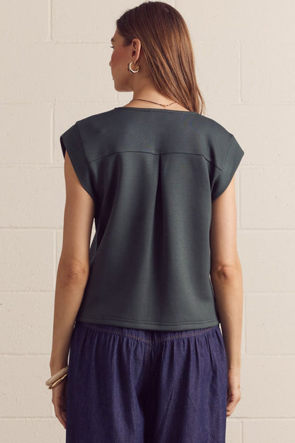 Solid cap sleeve top featuring center front seam detail. V-neck. Back yoke with center pleat. Knit. Unlined. Non-sheer. Lightweight.